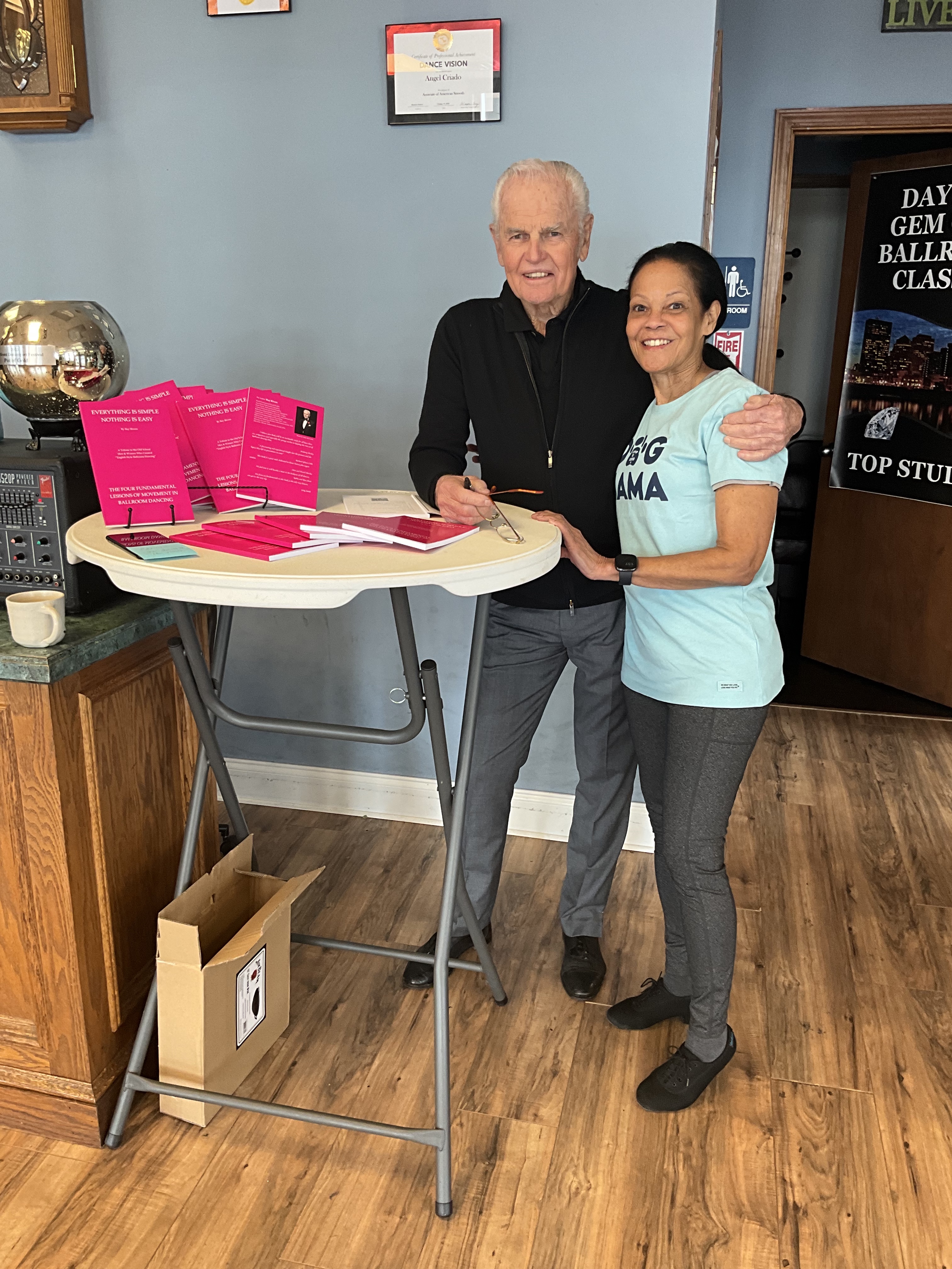 Ray Rivers with student and his book Everything is Simple. Nothing is Easy.