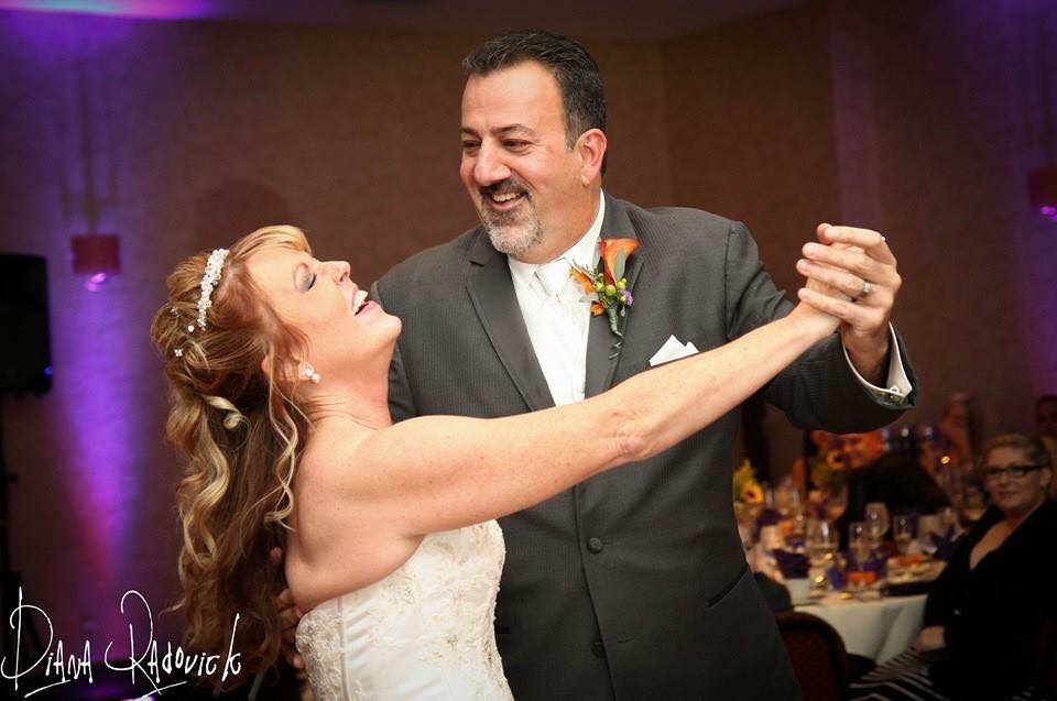 Wedding couple dancing with genuine smiles